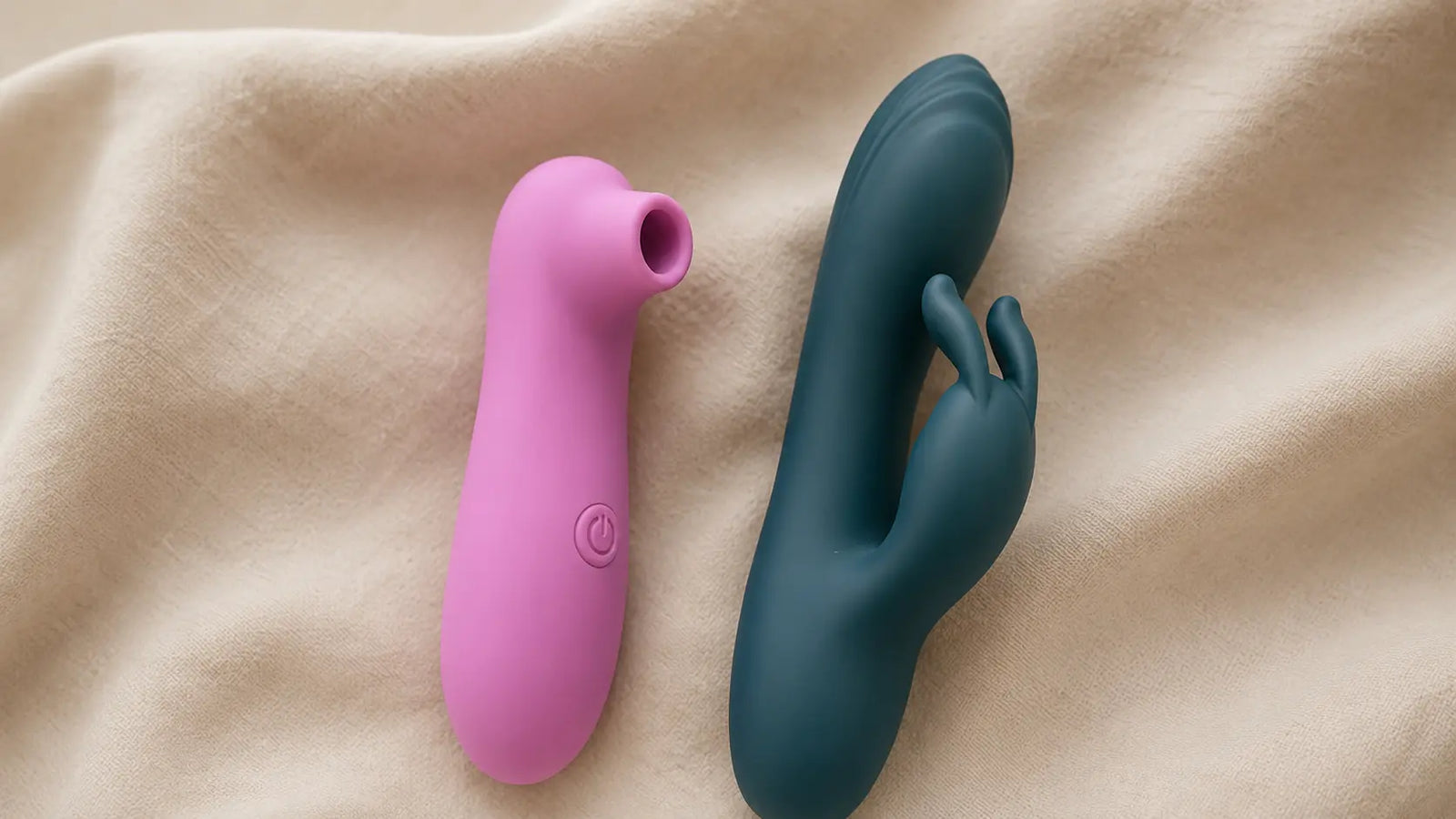 Un succhia clitoride e un vibratore affiancati su una superficie neutra, in un'immagine pulita e discreta